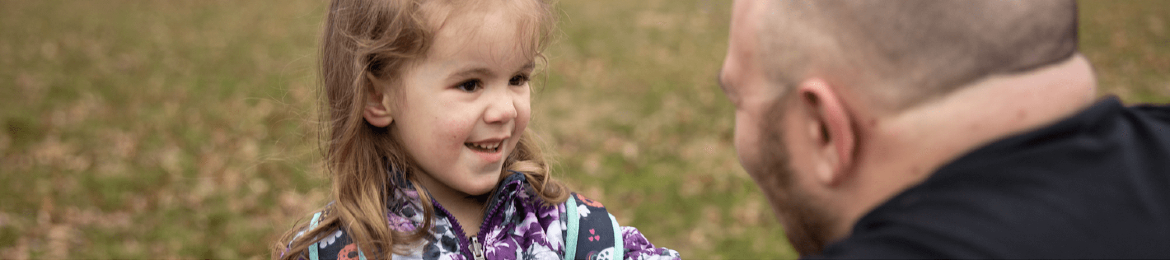 Toddler with Autism smiling at father