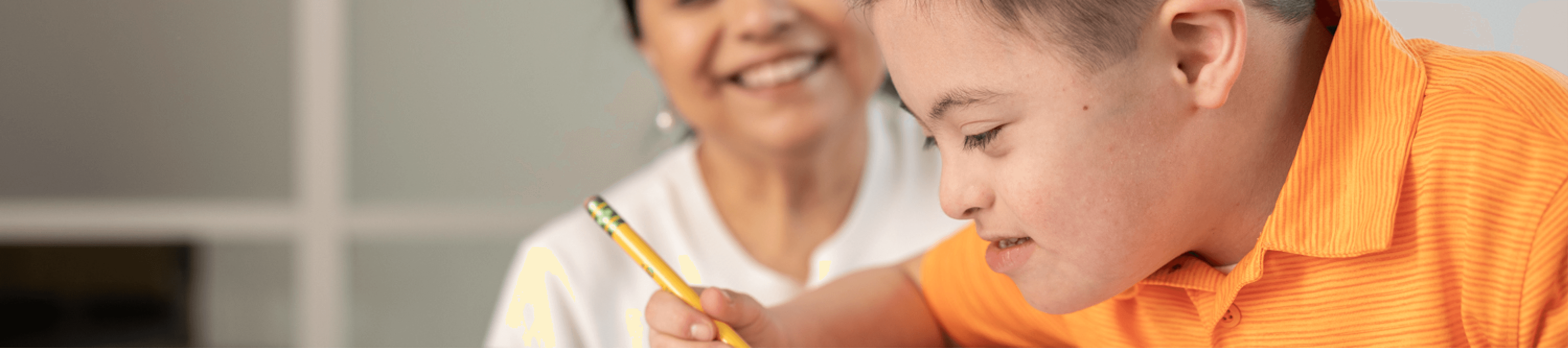 Grade schooler with Down syndrome does homework with mom